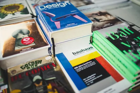 Stack of printed books and magazines with colorful covers