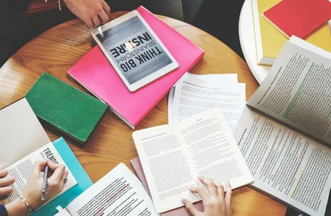 Open books and colorful notebooks spread across a table